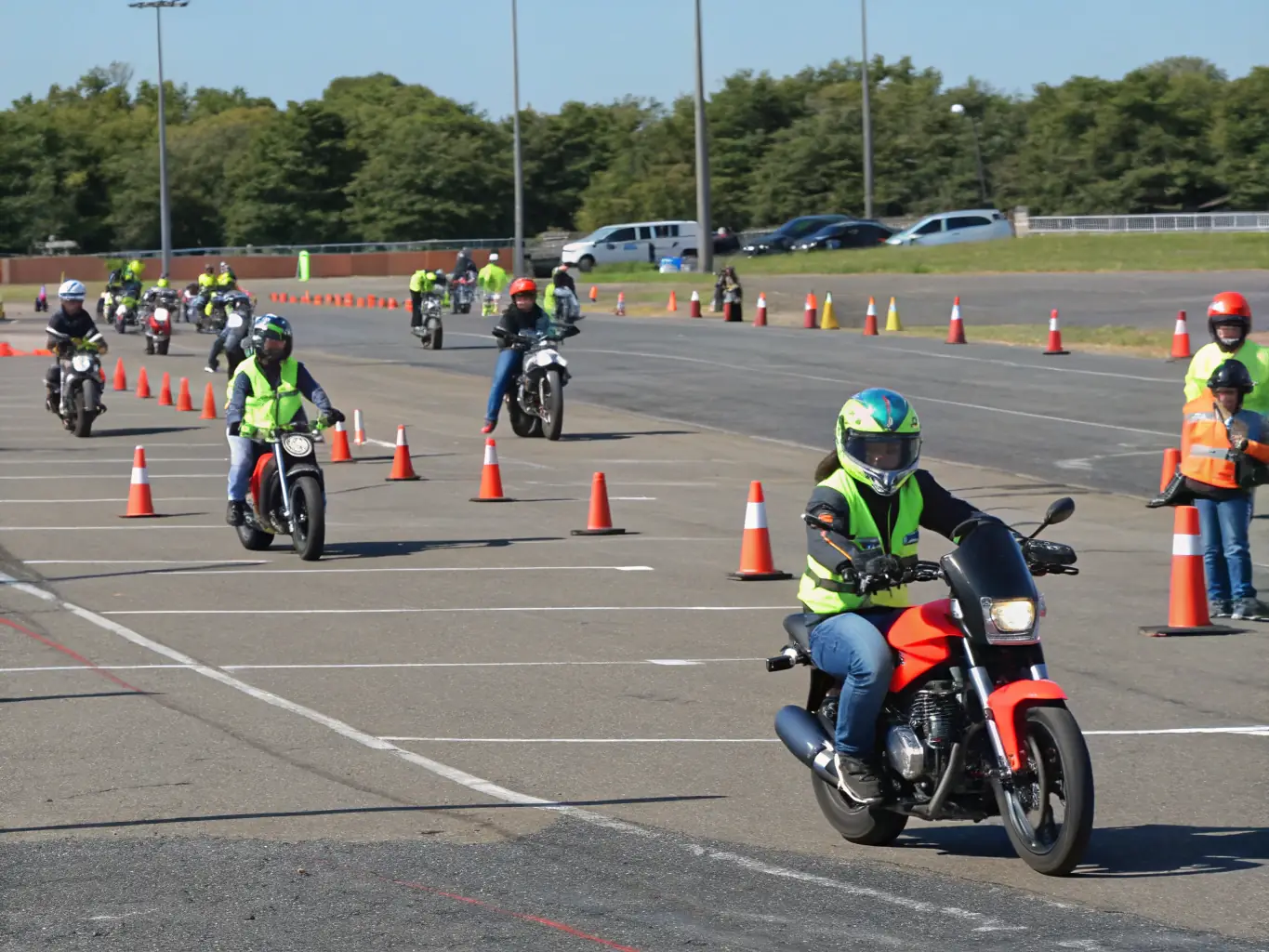 A photograph of a motorcycle safety training session, with instructors demonstrating proper riding techniques to participants.