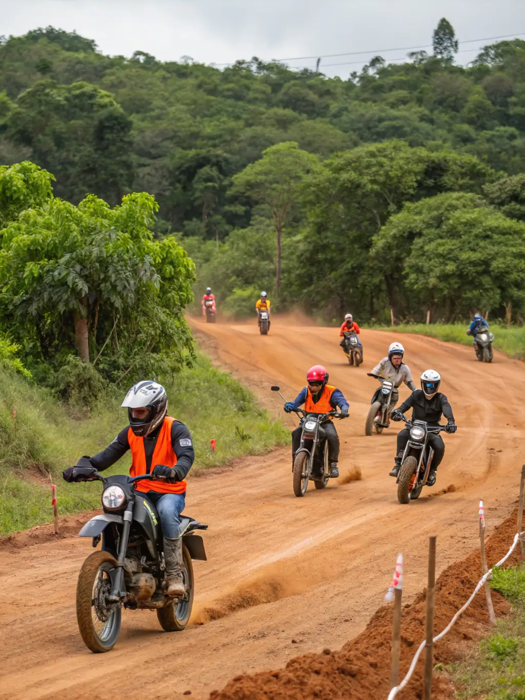 A group of motorcyclists participating in a safety training session, focusing on responsible riding techniques and hazard awareness, with the MOTOCLUB SEGONZACAIS logo subtly visible in the background.